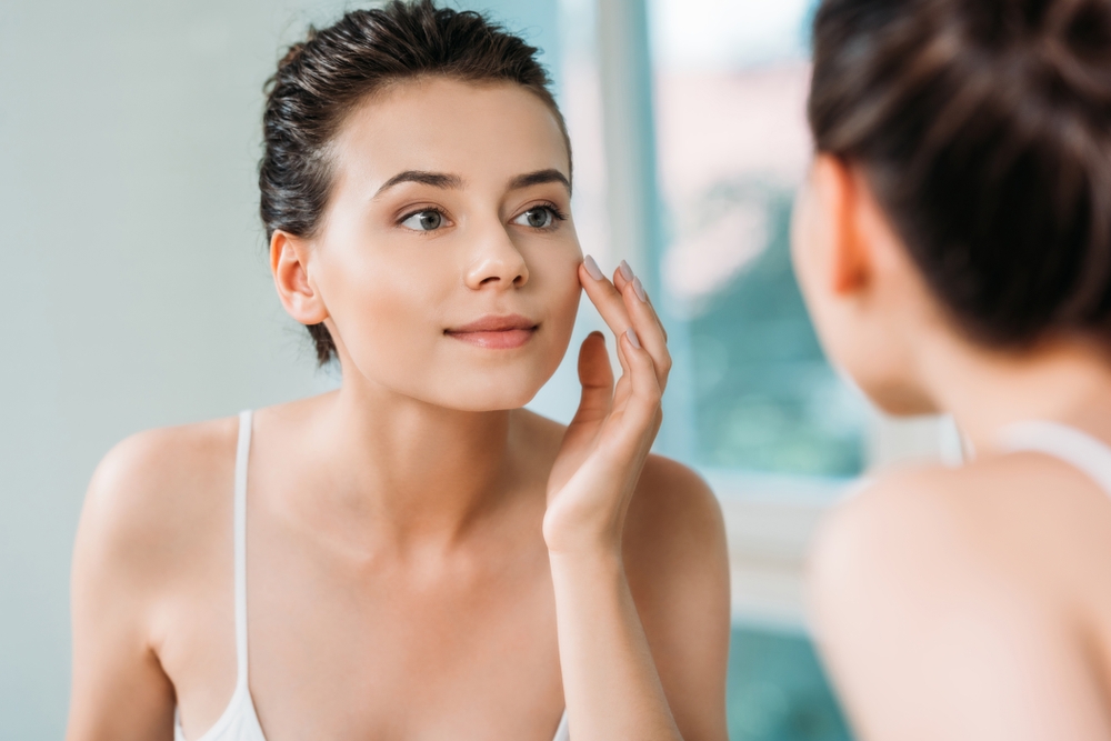 Woman touching face - beauty myths