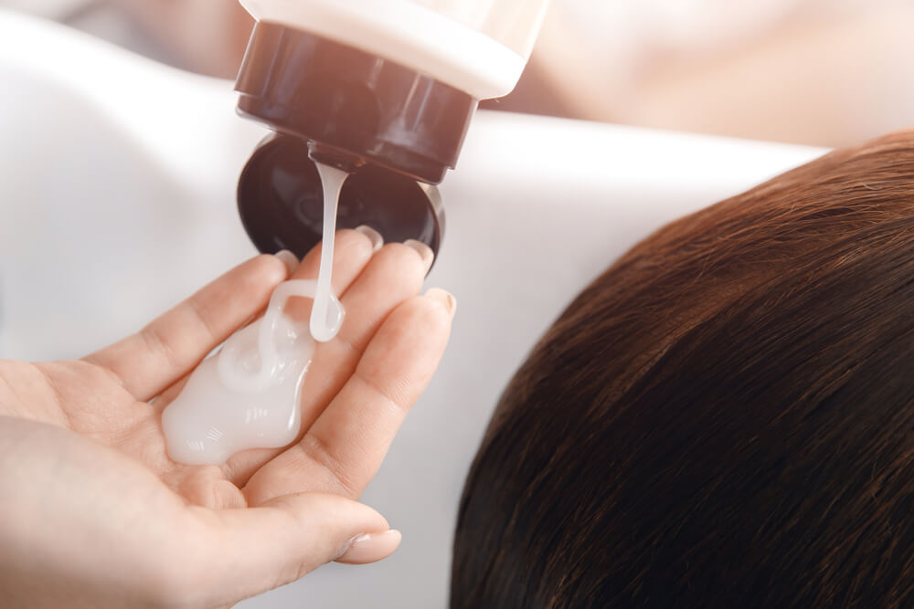 Woman using conditioner