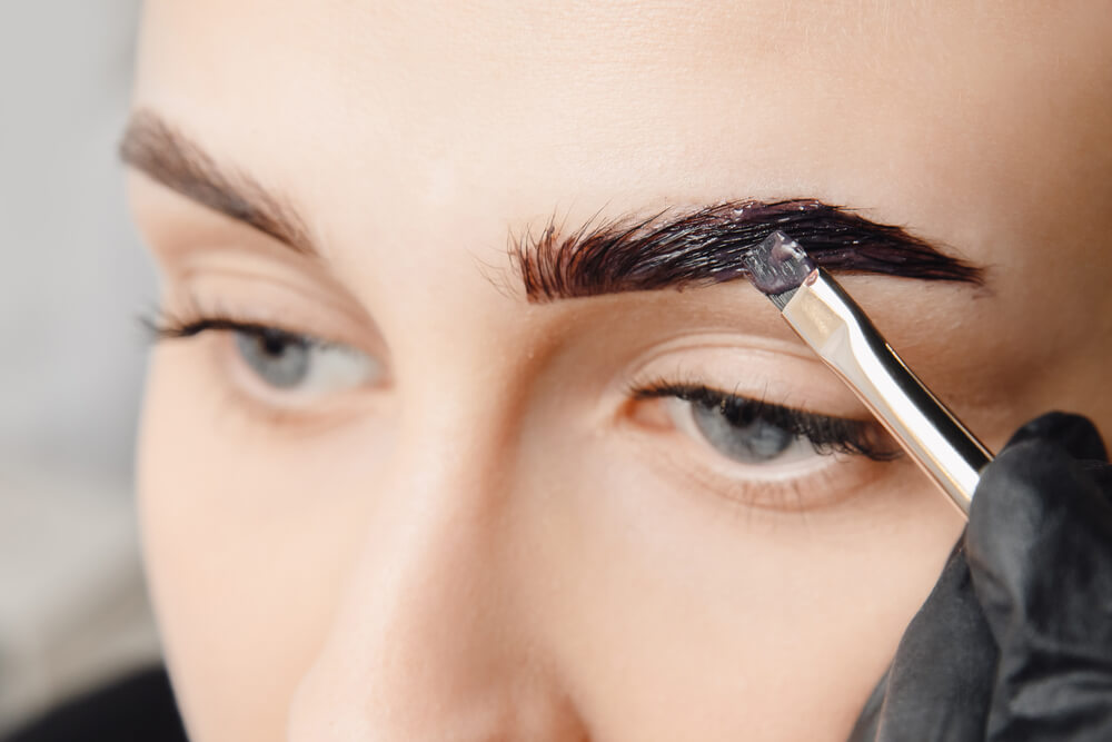 Woman tinting eyebrows
