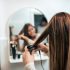 Woman straightening hair