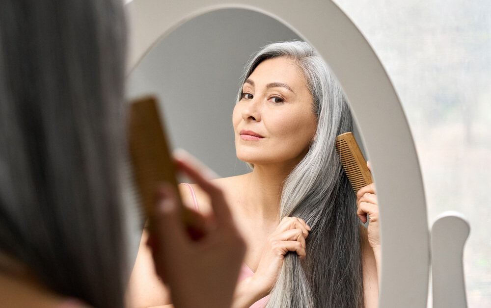 Woman brushing gray hair
