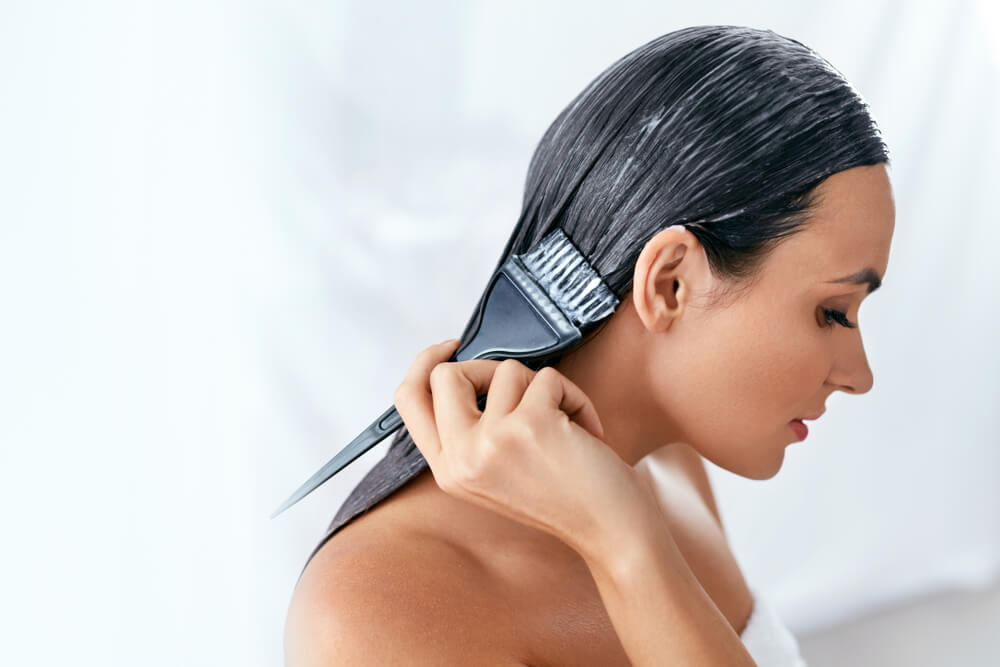 Woman applying hair mask