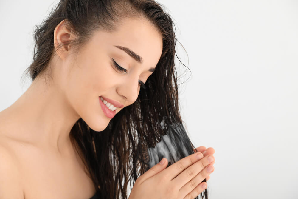 Woman using conditioner