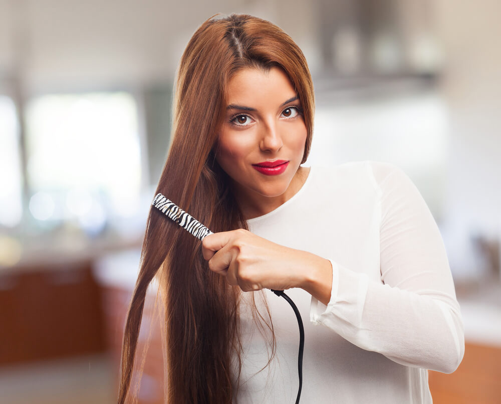 Woman using Evalectric hair straightener