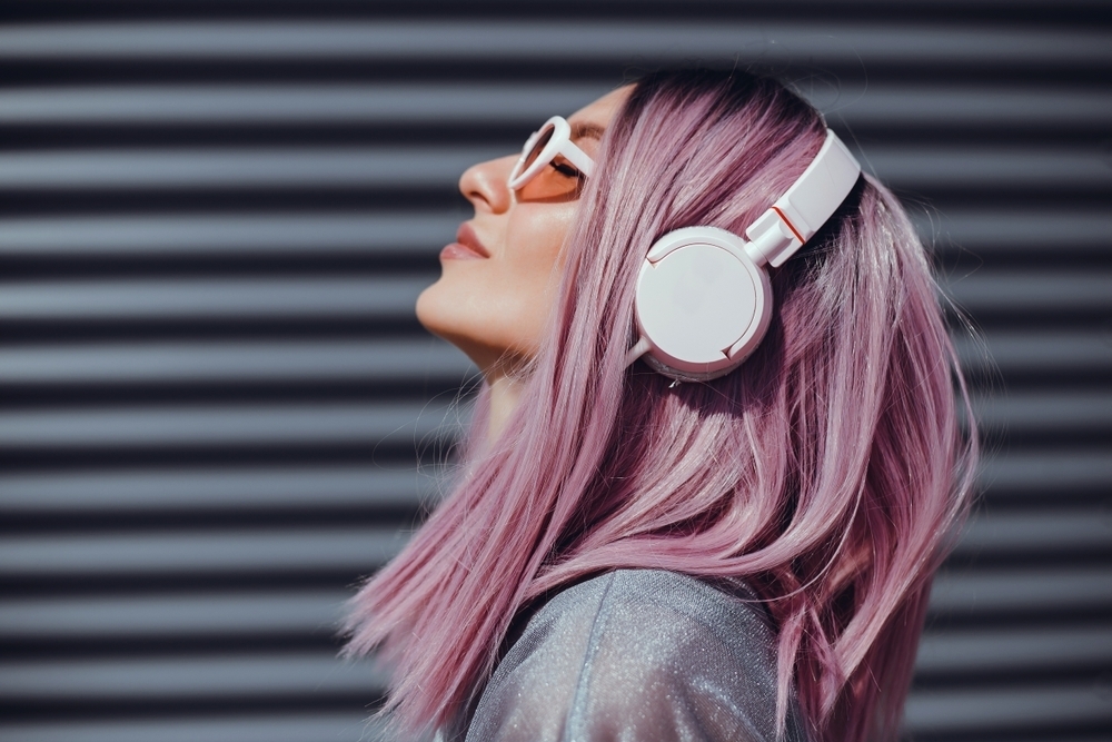 Woman with pink hair and headphones - fun hairstyles