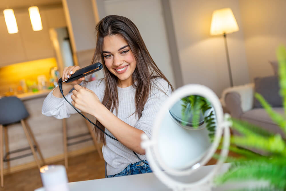 Woman using evolution straightener to straighten hair