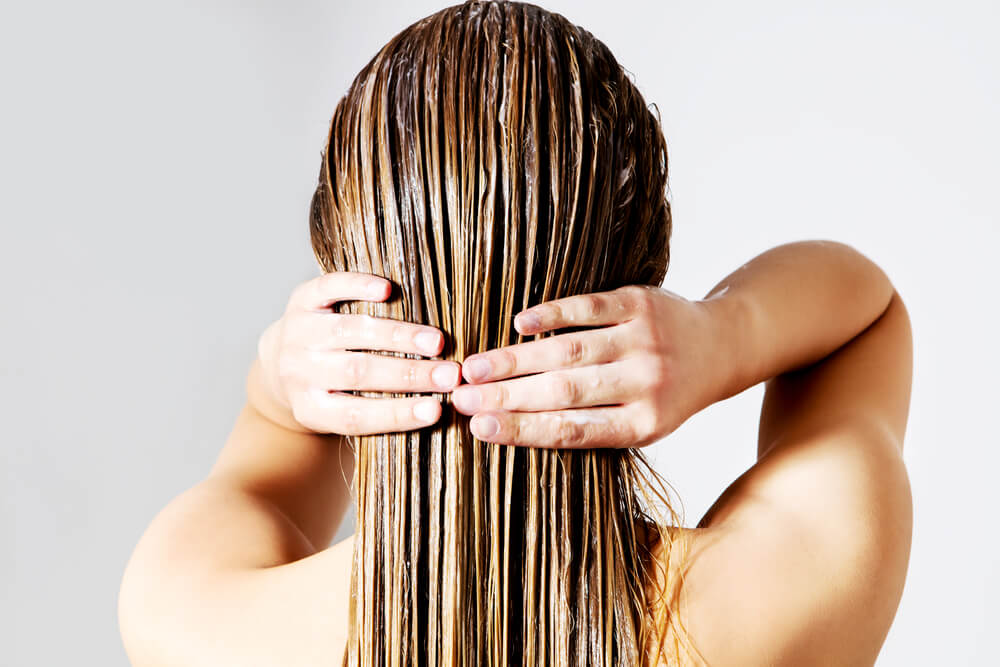 Woman applying hair mask