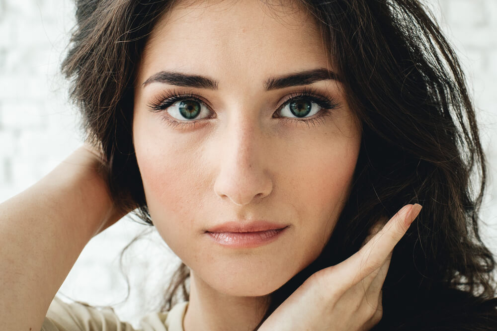 Woman with dark hair looking at camera