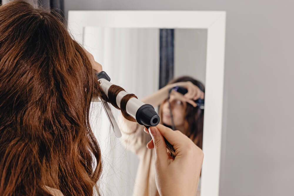 Woman curling hair