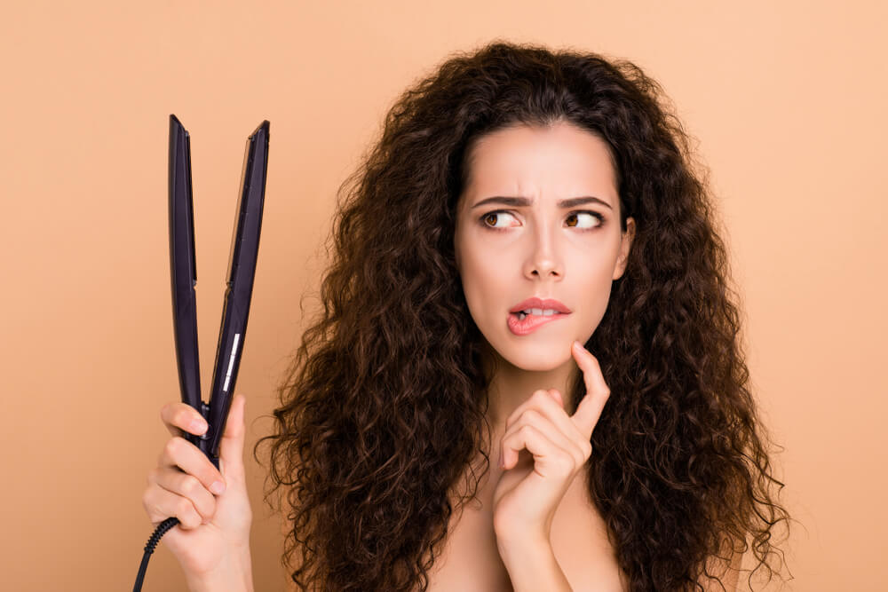 woman holding hair tool