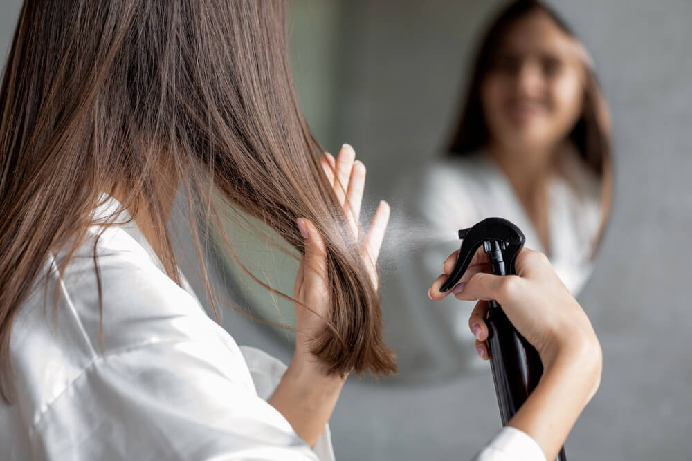 woman spraying hair