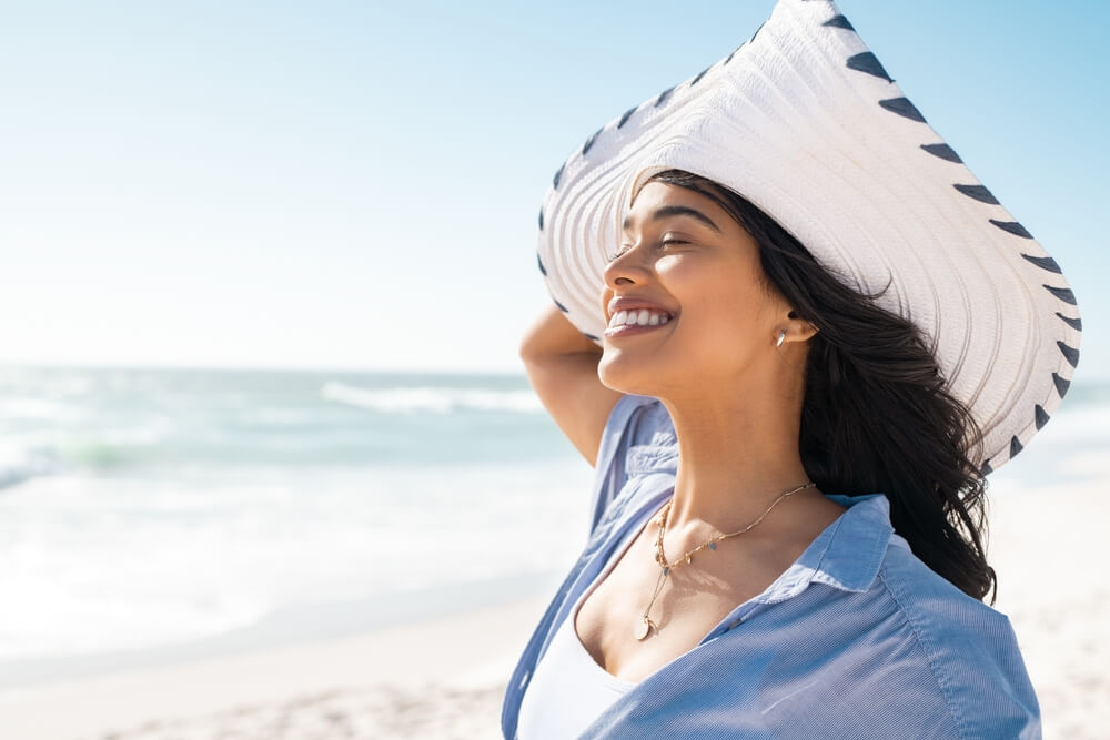 woman wearing hat on beach